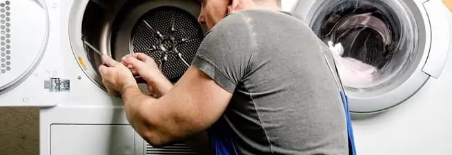 Dryer repair technician fixing a clothes dryer drum in Santa Ana, CA