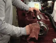 Vacuum repair technician cleaning and servicing a vacuum motor in Santa Ana, CA